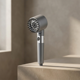 Aurve Filtered Shower Head standing on a stone bathroom ledge